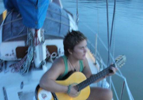 girl with guitar on boat