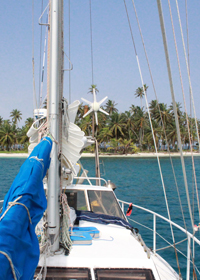 sailboat-karl-with-island sailboat Karl in front of palm tree island in San Blas